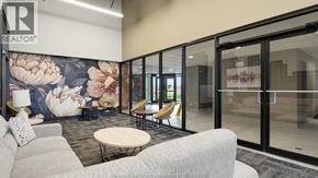 Lasalle condo for rent - A modern office space with a floral mural on the wall and glass walls leading to another room.