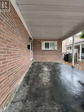 Toronto (Pleasant View) apartment for rent - A brick wall with a window and a door in the background.