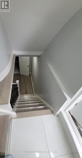 Pickering (Village East) apartment for rent - A staircase with a white railing and a white door at the top.