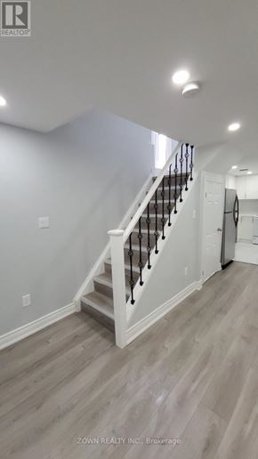 Pickering (Village East) apartment for rent - A staircase with a white railing and wooden steps.