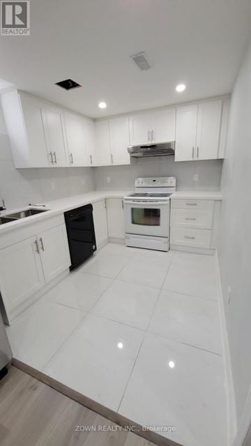Pickering (Village East) apartment for rent - A white kitchen with a black oven and white cabinets.