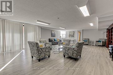 London East (East K) condo for rent - A living room with a grey sofa set and wooden flooring.