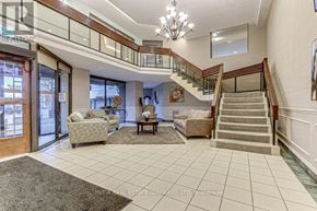 London East (East K) condo for rent - A spacious living room with a staircase and a chandelier.