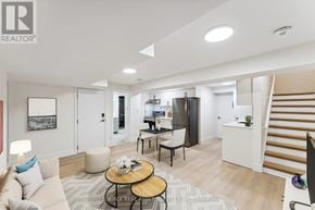Ottawa apartment for rent - A living room with a couch, coffee table, and a staircase.