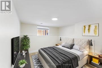 Ottawa apartment for rent - A bedroom with a large bed and a flat screen TV.