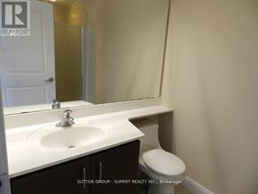 Mississauga (City Centre) condo for rent - A white sink in a bathroom with a toilet in the corner.