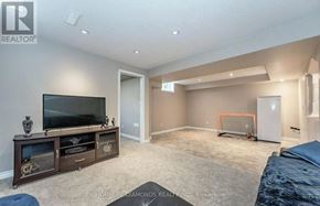 Kitchener apartment for rent - A living room with a flat screen TV and a hockey goal in the corner.