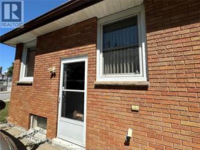 Windsor apartment for rent - A red brick house with a white door and window.