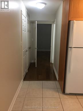 Toronto (Weston-Pellam Park) apartment for rent - A hallway with a white refrigerator on the right.