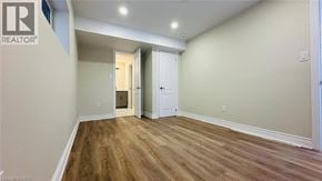 Kitchener apartment for rent - A room with wooden flooring and white walls, with a doorway leading to another room.