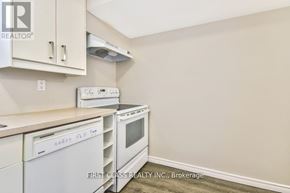 Toronto (Guildwood) apartment for rent - A kitchen with white appliances and cabinets.