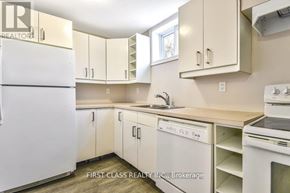 Toronto (Guildwood) apartment for rent - A kitchen with white appliances and cabinets.