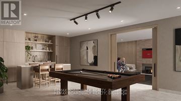 Ottawa condo for rent - A modern living room with a pool table and a bar area.