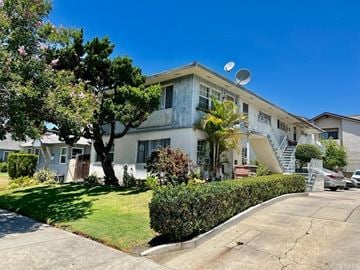Glendale apartment for rent - A white two-story house with a tree in front.