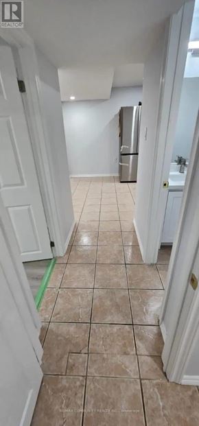Brampton (Fletcher's West) apartment for rent - A hallway with a tiled floor and a refrigerator in the background.