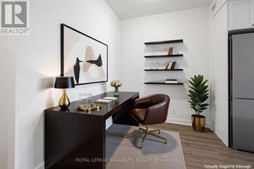Clarington (Bowmanville) condo for rent - A modern living room with a brown leather chair and a painting on the wall.