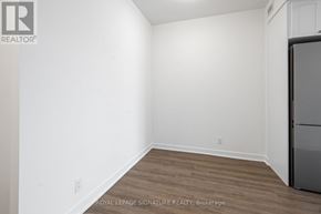 Clarington (Bowmanville) condo for rent - A white wall with a Royal LePage logo and a wood floor.