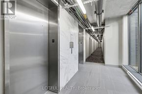 Ottawa condo for rent - A long hallway with a metal elevator on the left and a carpeted area on the right.