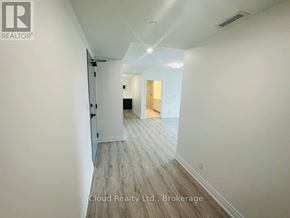 Windsor condo for rent - A hallway with wood flooring and white walls.