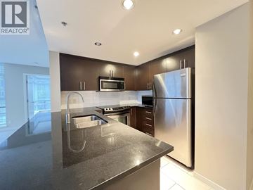 Coquitlam apartment for rent - A modern kitchen with a stainless steel refrigerator and microwave.