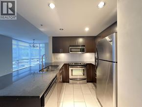 Coquitlam apartment for rent - A modern kitchen with stainless steel appliances and a large island.