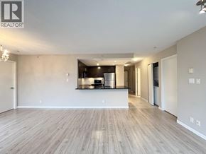 Coquitlam apartment for rent - A spacious living room with a kitchen area in the background.