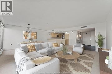 Windsor condo for rent - A living room with a white couch and a coffee table.