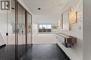 Windsor condo for rent - A hallway with a glass door leading to a balcony.