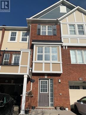 Brampton (Fletcher's West) townhouse for rent - A house with a brown door and a car parked in front.