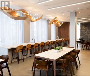 Brampton (Northwest Brampton) condo for rent - A modern dining room with a long table and chairs.