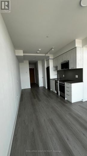 Brampton (Northwest Brampton) condo for rent - A long, narrow hallway with a kitchen area at the end.