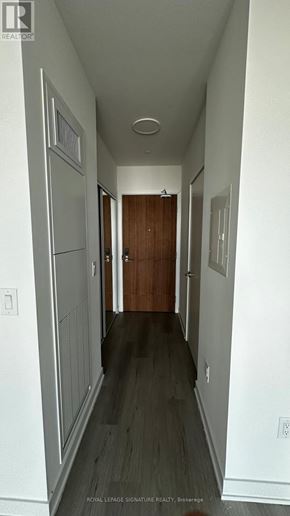 Brampton (Northwest Brampton) condo for rent - A long hallway with a brown door at the end.