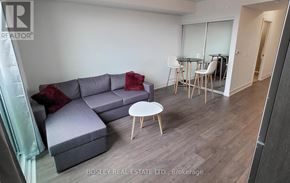 Oshawa (Windfields) house for rent - A living room with a grey couch and a white coffee table.