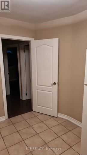 Toronto (Rockcliffe-Smythe) apartment for rent - A white door is in a room with tiled flooring.