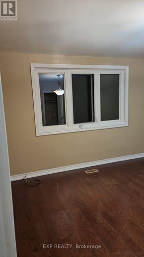 Toronto (Rockcliffe-Smythe) apartment for rent - A room with a window and wooden flooring.