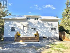 Prince Edward County (South Marysburgh) apartment for rent - A white house with a porch and a small front yard.