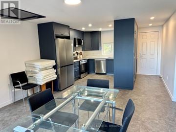 Prince Edward County (South Marysburgh) apartment for rent - A modern kitchen with a glass table and stainless steel appliances.