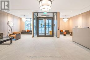 Toronto (Yorkdale-Glen Park) condo for rent - A modern office lobby with a glass door entrance and a reception desk.
