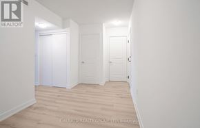 Toronto (Yorkdale-Glen Park) condo for rent - A white hallway with two doors and a brokerage sign.