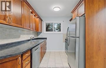 Windsor townhouse for rent - A kitchen with wooden cabinets and a refrigerator.