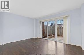 Windsor townhouse for rent - A room with a sliding glass door leading to a backyard.