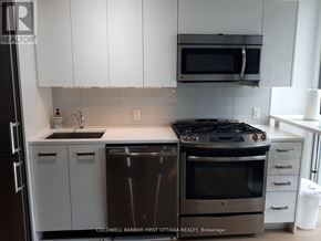 Ottawa condo for rent - A modern kitchen with a stainless steel dishwasher and oven.