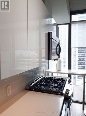 Ottawa condo for rent - A modern kitchen with a stove top oven and a microwave.