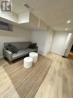 Toronto (Oakwood Village) apartment for rent - A living room with a grey couch and a brown rug.
