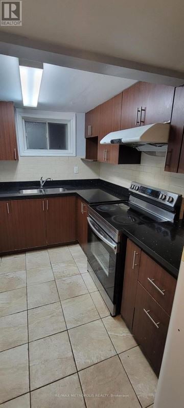 Toronto (Bendale) apartment for rent - A kitchen with brown cabinets and black countertops.