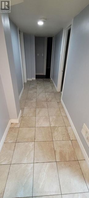 Toronto (Bendale) apartment for rent - A hallway with tiled floors and a door at the end.