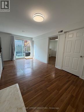 Aurora (Aurora Grove) townhouse for rent - A room with wooden floors and white walls, with a door on the right side.