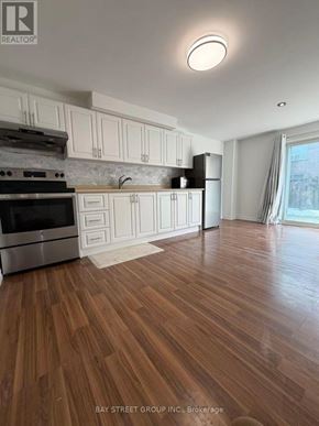 Aurora (Aurora Grove) townhouse for rent - A kitchen with wooden floors and white cabinets.