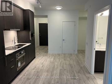 Toronto (Newtonbrook East) condo for rent - A kitchen with dark wood cabinets and a white countertop.
