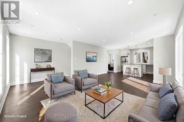 Ottawa apartment for rent - A living room with a grey couch, a coffee table, and a painting on the wall.